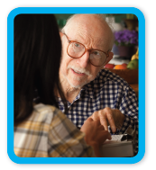 Picture of man facing camera talking to a woman.